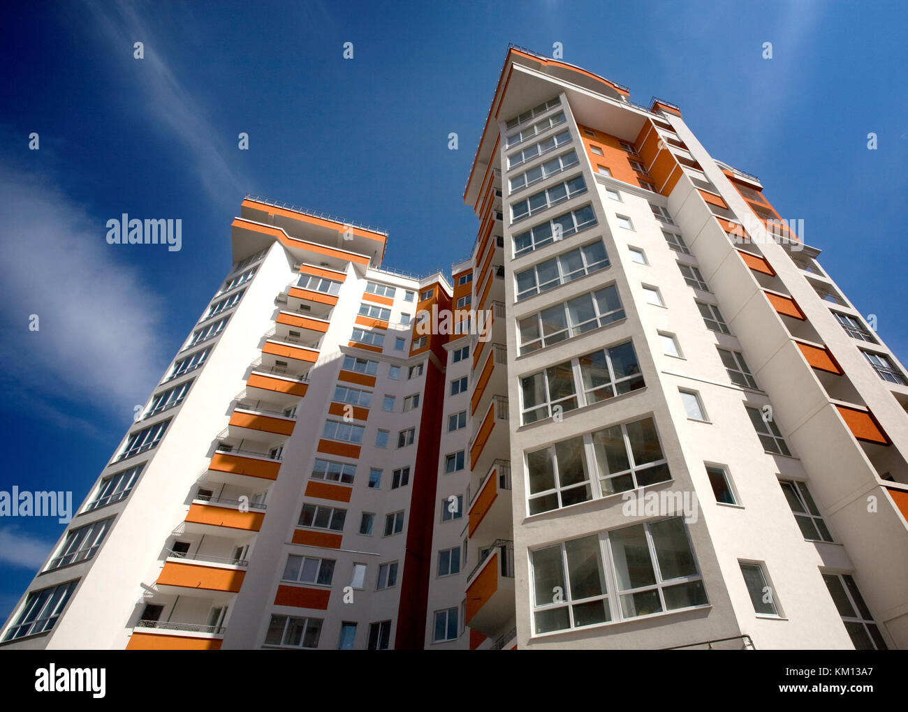 Modern apartment building against blue sky background Stock Photo - Alamy