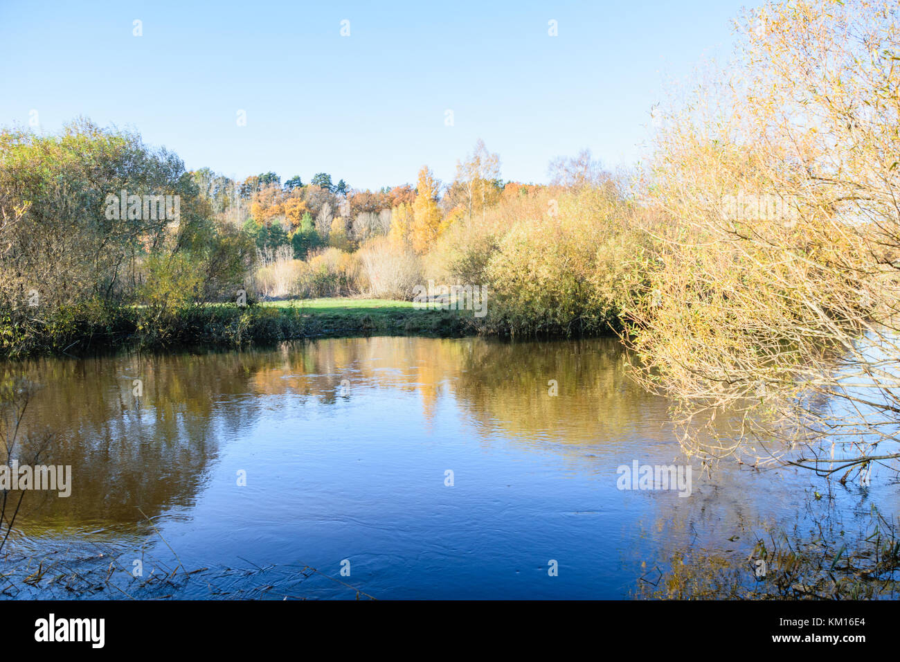 lake with water reflections in colorful autumn day with white clouds in ...