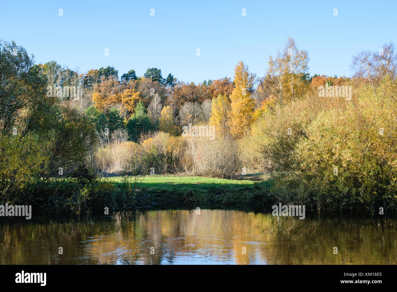lake with water reflections in colorful autumn day with white clouds in ...