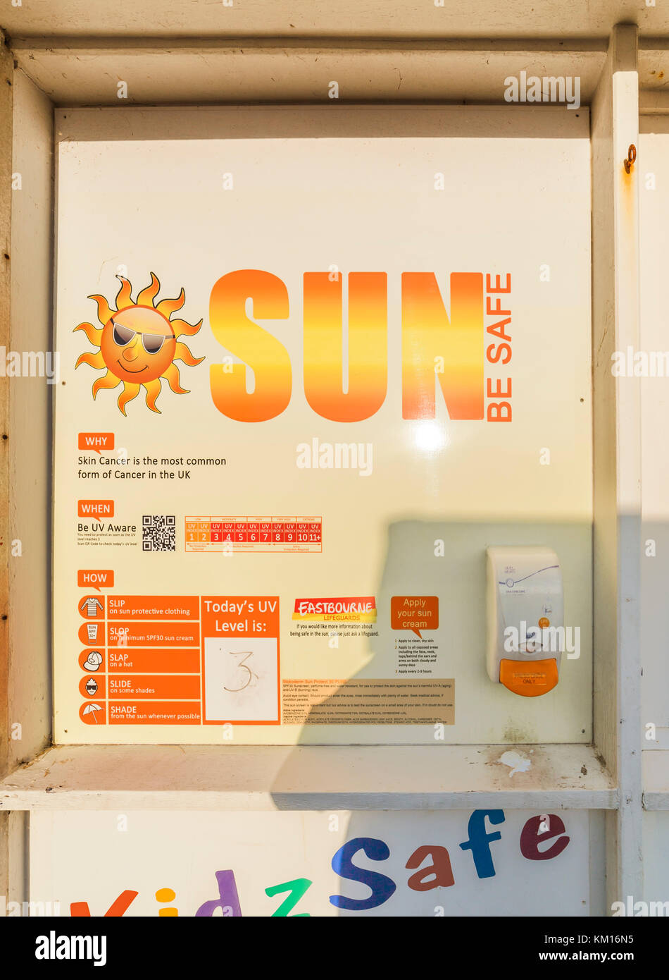 Free sunscreen dispenser on Eastbourne seafront. Stock Photo