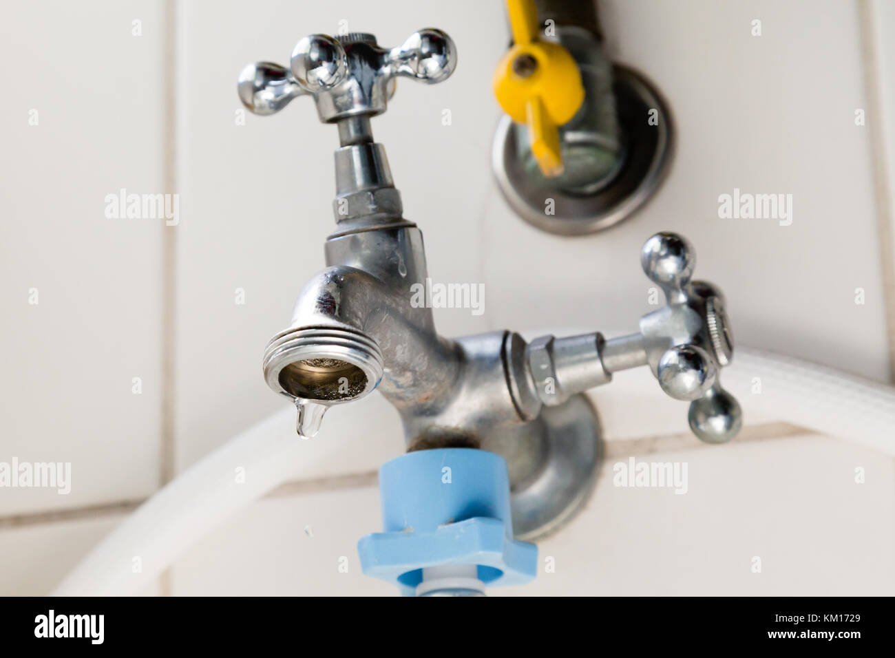 Laundry tap with dripping water drop, water leaking, saving concept
