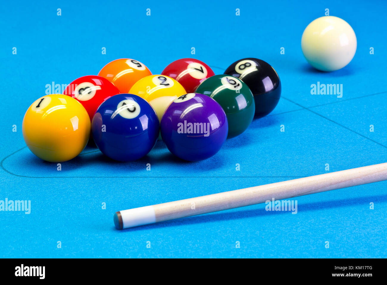 Billiard pool game nine ball with nineball balls set up with cue on  billiard table with blue cloth Stock Photo - Alamy