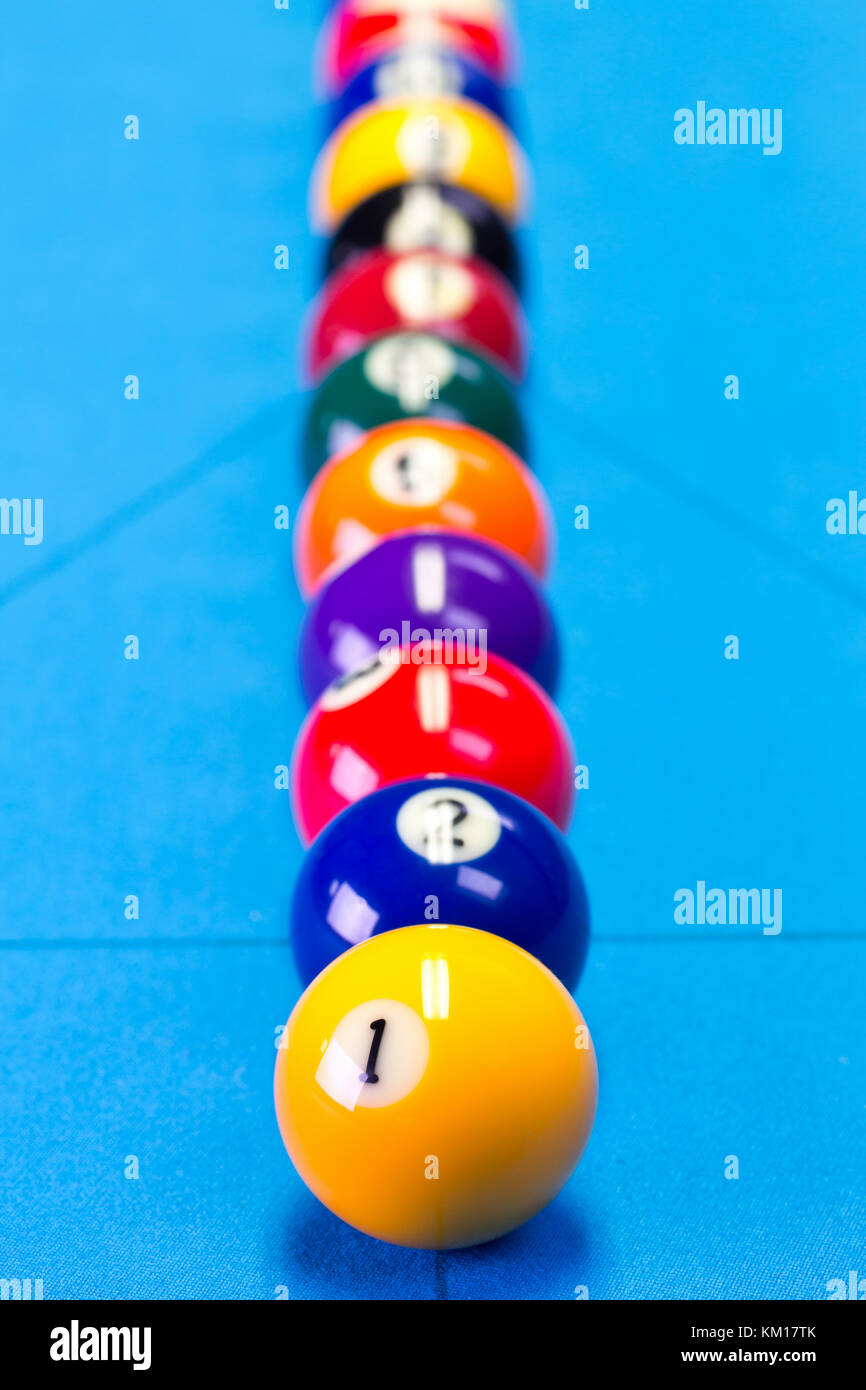 Billiard pool game balls lined up on billiard table with blue cloth