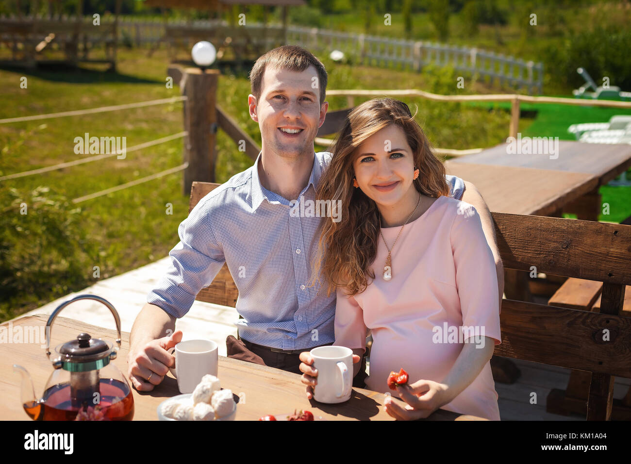 future parents drinking tea outdoors Stock Photo