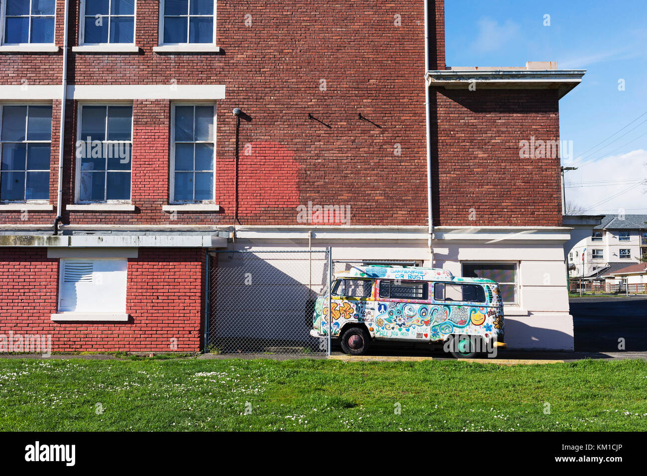 Colourful VW van parked by a school.   Victoria BC Canada Stock Photo