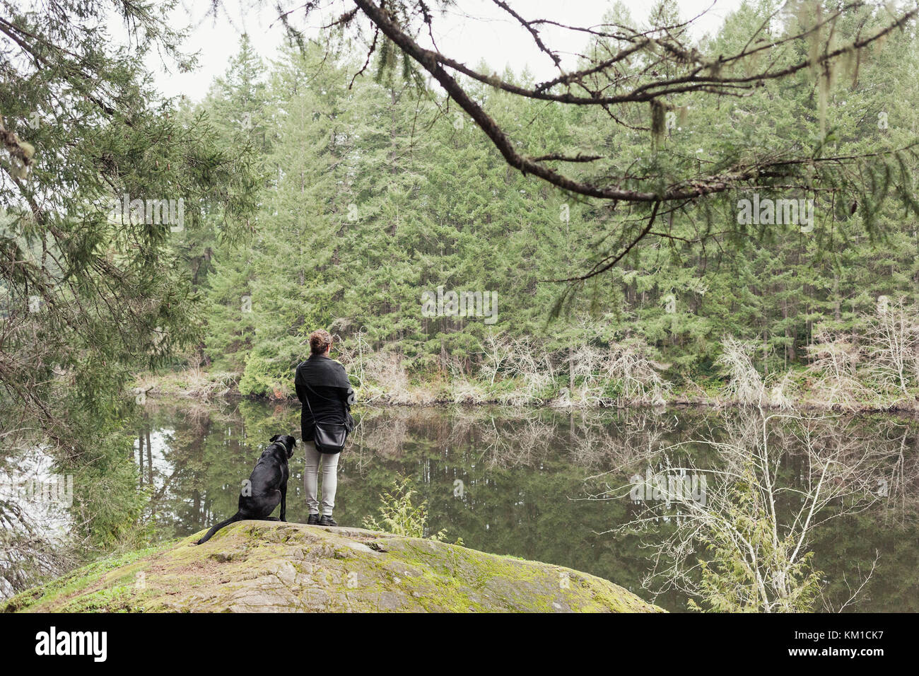 Woman and her dog at lake.  Thetis Lake, Vancouver Island Canada Stock Photo