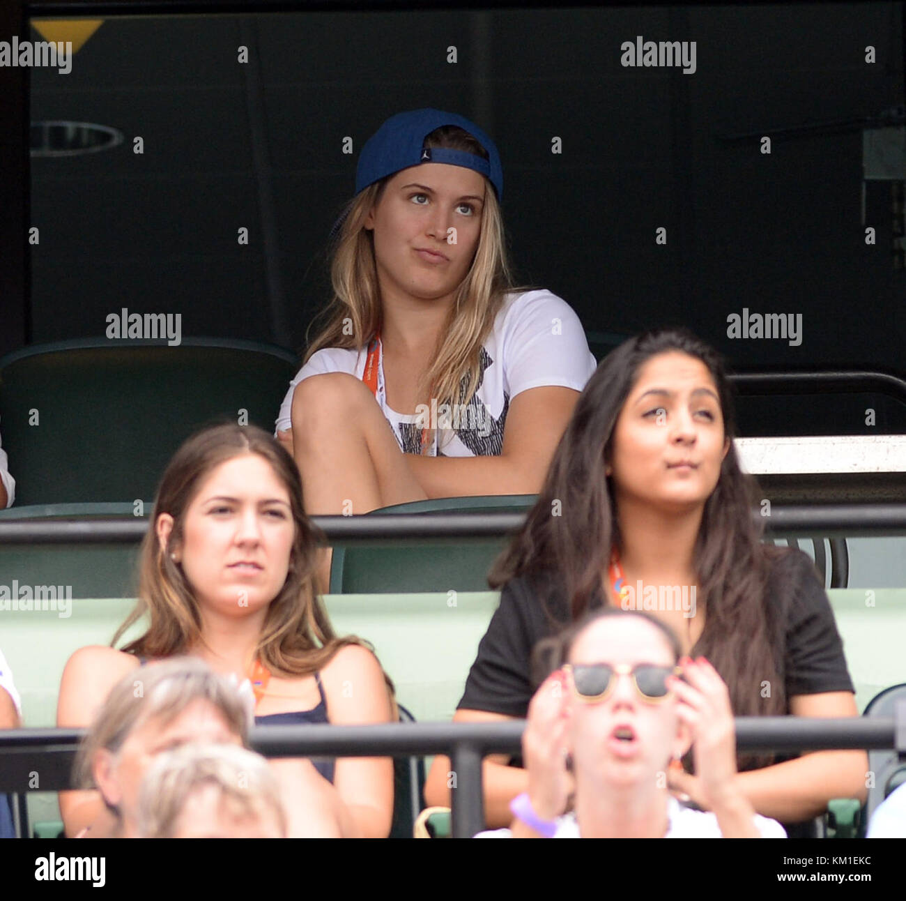 KEY BISCAYNE, FL - MARCH 28: Tennis player Eugenie Bouchard looks Smitten with someone on her cell phone while she watches Grigor Dimitrov of Bulgaria defeat Andy Murray of Great Britain day 8 of the Miami Open presented by Itau at Crandon Park Tennis Center on March 28, 2016 in Key Biscayne, Florida.   People:  Eugenie Bouchard Stock Photo