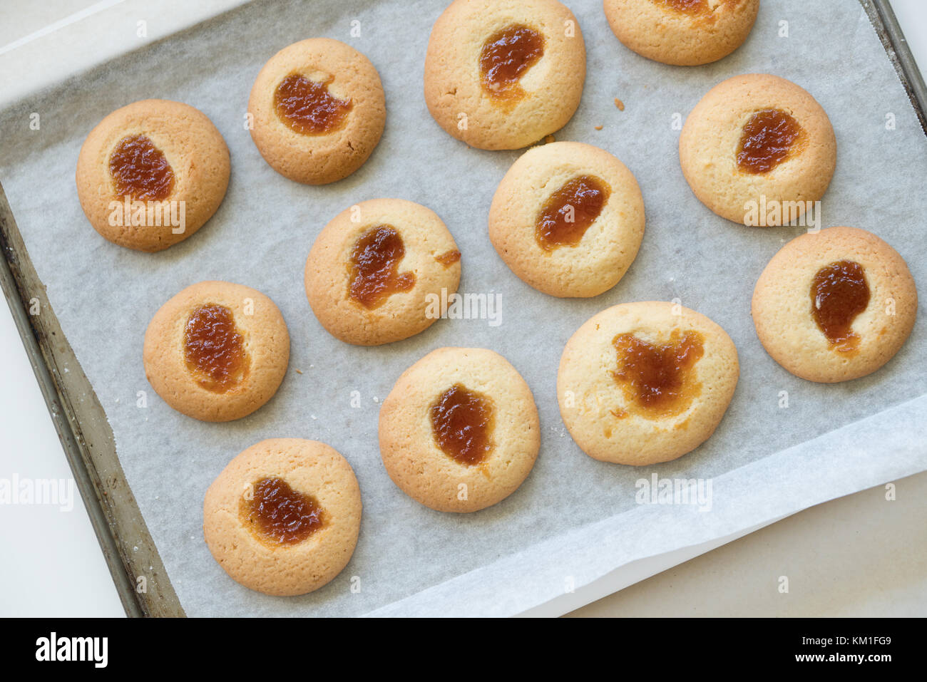 Jam drop cookies on baking tray just out of oven Stock Photo