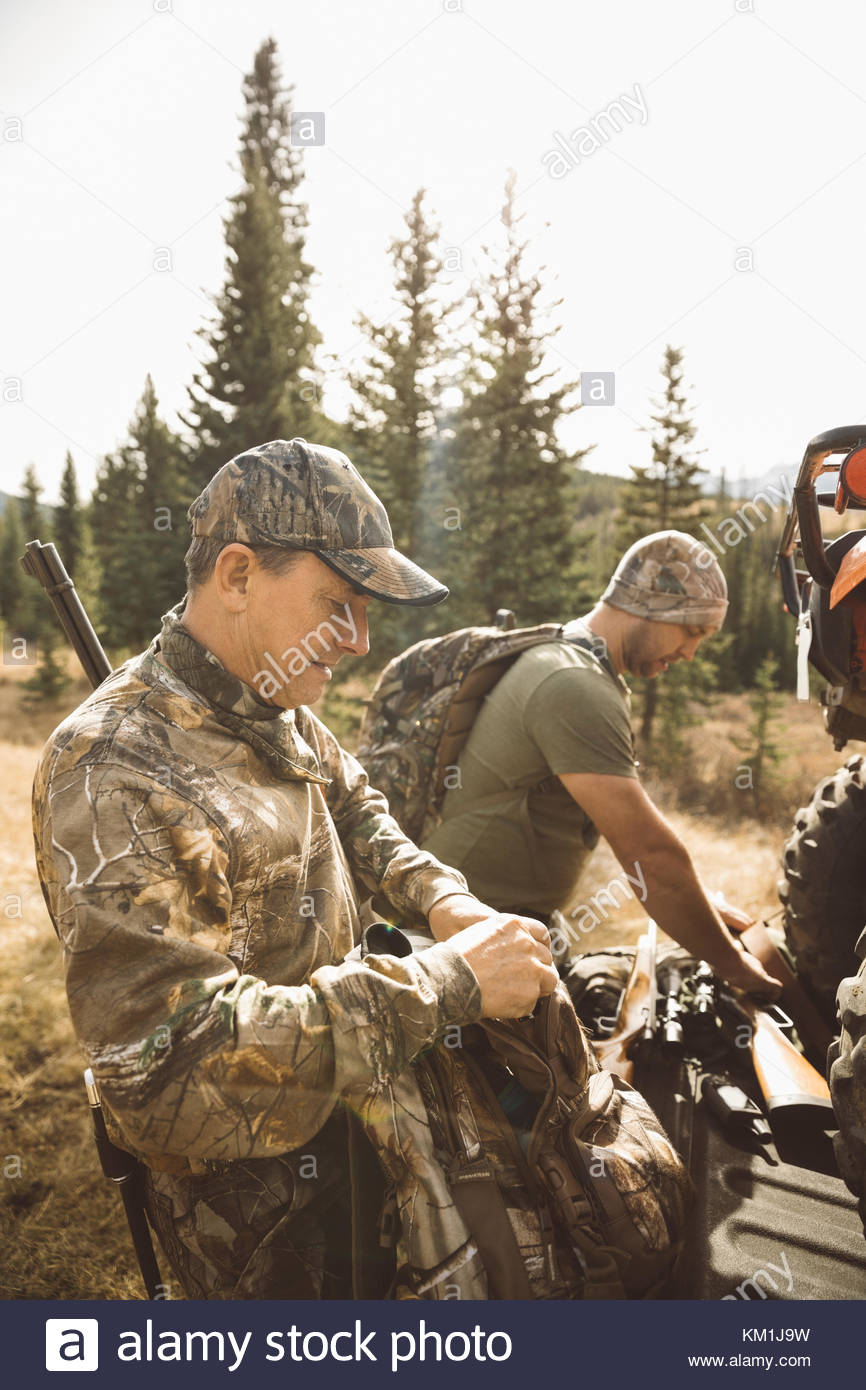 Father and son hunters preparing hunting equipment Stock Photo Alamy