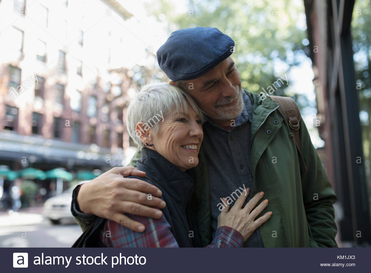 Senior couple window shopping at urban storefront Stock Photo