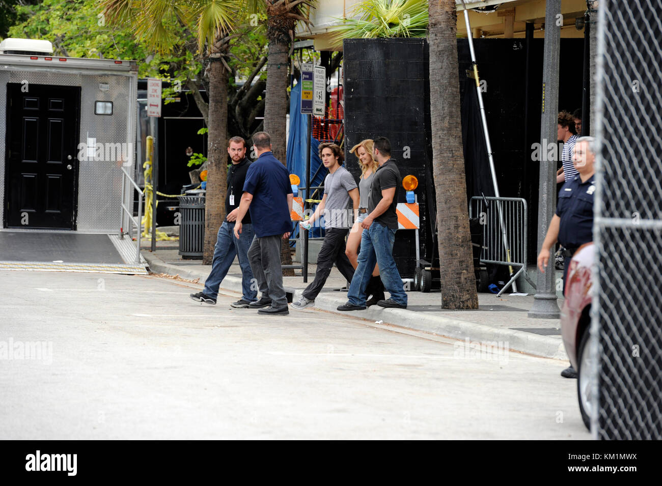 FORT LAUDERDALE, FL - JUNE 18: (EXCLUSIVE COVERAGE)   Tom Cruise refuses to be photographed on the set of Rock of Ages.  Cruise was driven around in a red golf cart (which was all covered up) and flanked by security from his trailer to the door of the club (which was like 30 feet away); fans were saying Tom, looked ridicules riding across the street rather than walking.  Everyone was very disappointed when The A list actor refused to take pictures or sign autographs, after he was heckled by fans and photogs that were screaming 'I heard this movie is going strait to video' and 'Tom I hope you d Stock Photo