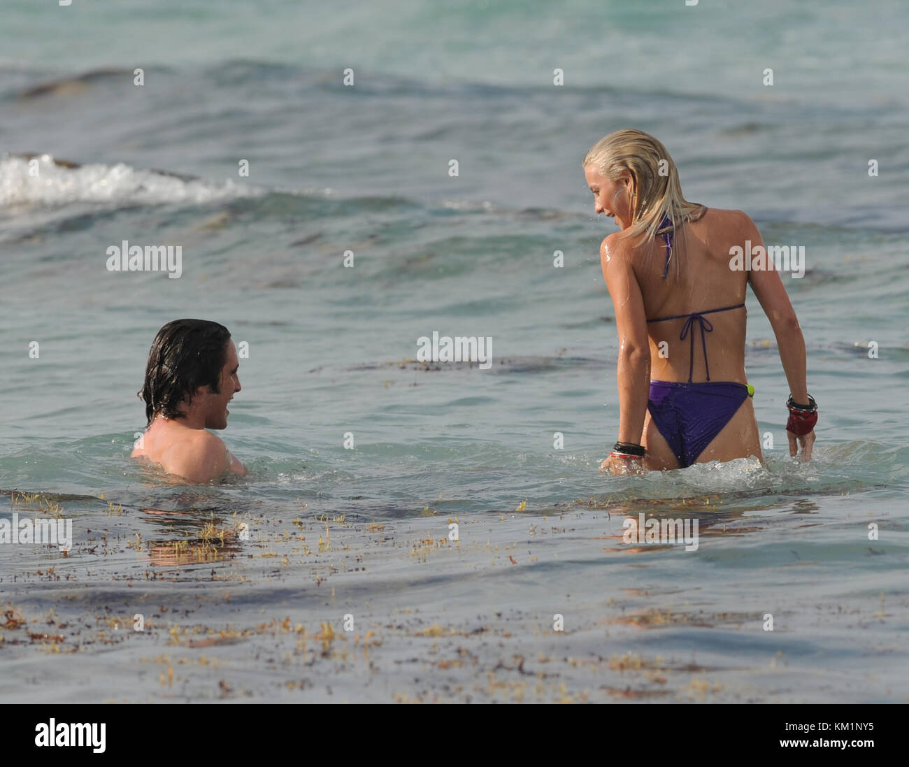 SMG Julianne Hough Diego Boneta Bikini Kiss 052311 94.JPG  HOLLYWOOD, FL - MAY 23:  Julianne Hough (wearing a smoking hot purple bikini) and Diego Boneta enjoyed a 'make out' kissing session in the ocean day one on the set of 'Rock of Ages' starring Tom Cruise. Julianne looked like she was having so much fun with her co-star Diego.  After she was done devouring Diego the insatiable star got out of the water and checked out some more 'hunky ' dudes on the beach but not before removing the seaweed from her beautiful blond locks.  WOW that’s a rap for day 1.  What will Ryan Seacrest say when he s Stock Photo