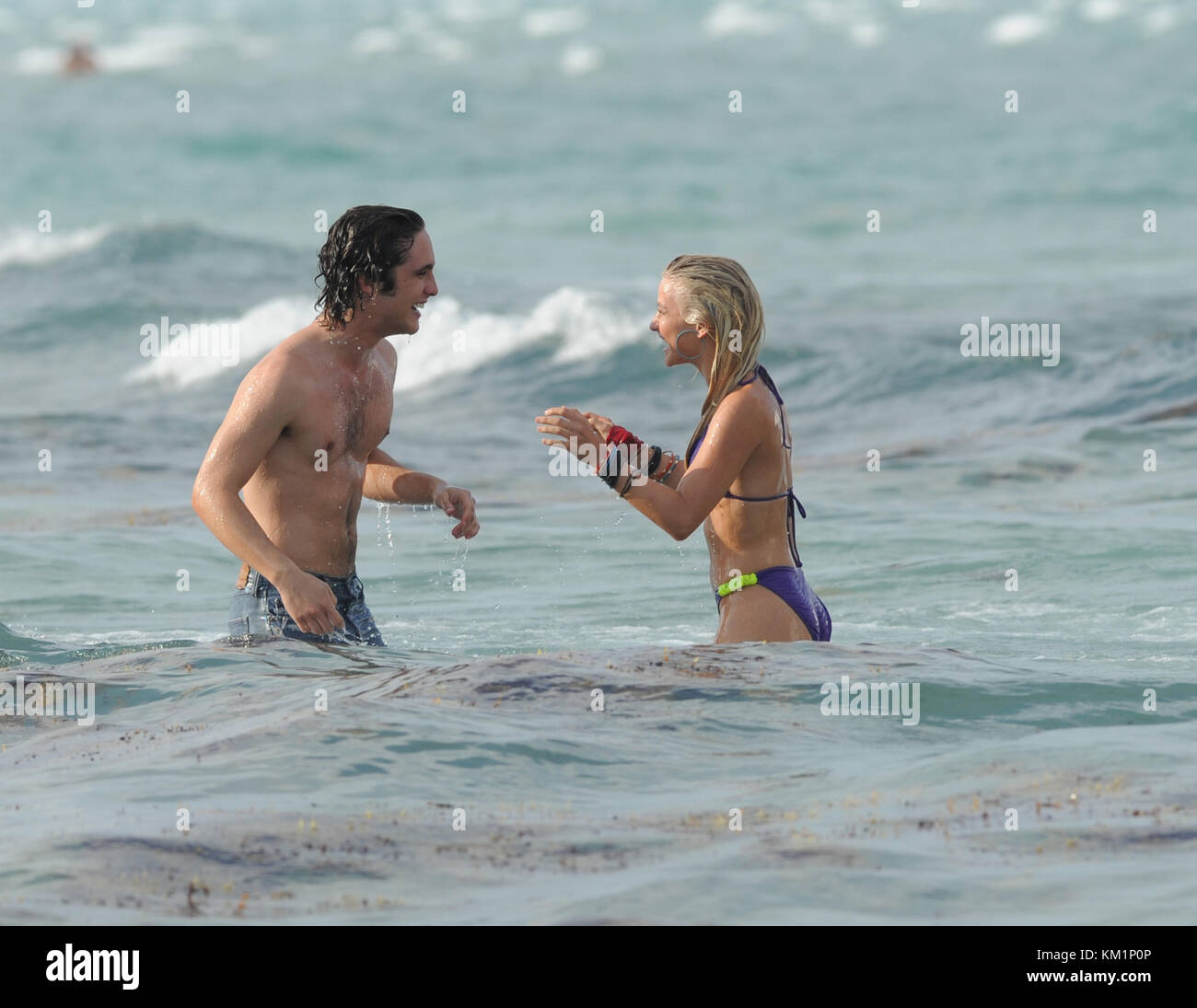 HOLLYWOOD, FL - MAY 23:  Julianne Hough (wearing a smoking hot purple bikini) and Diego Boneta enjoyed a "make out" kissing session in the ocean day one on the set of "Rock of Ages" starring Tom Cruise. Julianne looked like she was having so much fun with her co-star Diego.  After she was done devouring Diego the insatiable star got out of the water and checked out some more "hunky ' dudes on the beach but not before removing the seaweed from her beautiful blond locks.  WOW that’s a rap for day 1.  What will Ryan Seacrest say when he sees these pixs he better get to Miami Quick.    On May 23,  Stock Photo