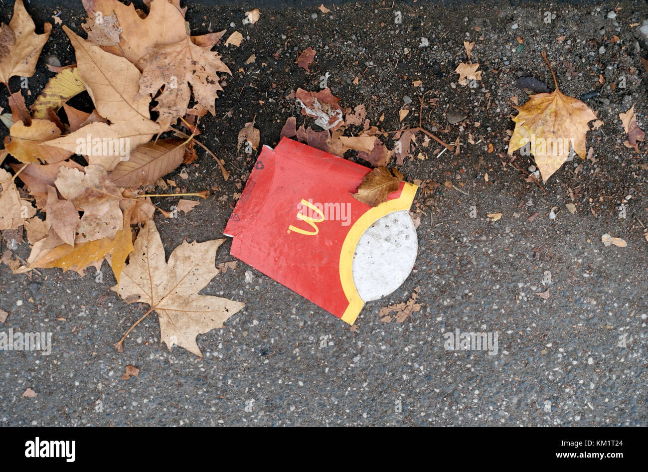 Mc Donald empty french fries container box left on the pavement of the street, close up Stock Photo