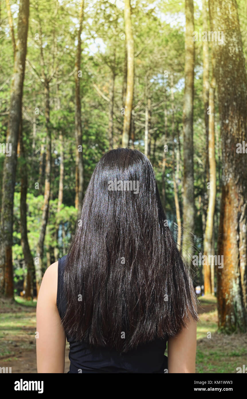 Photograph of girl's back in the forest Stock Photo