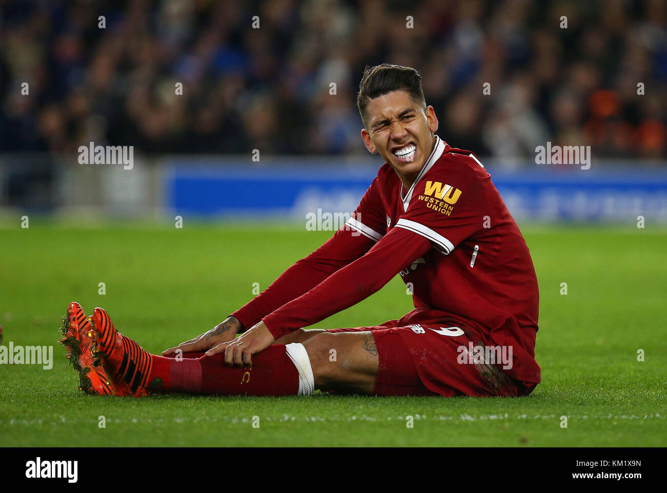 Roberto Firmino of Liverpool grimaces in pain during the Premier League match between Brighton and Hove Albion and Liverpool at the American Express Community Stadium in Brighton and Hove. 02 Dec 2017 *** EDITORIAL USE ONLY *** FA Premier League and Football League images are subject to DataCo Licence see www.football-dataco.com Stock Photo
