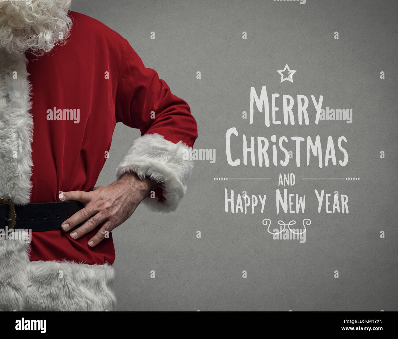 Confident Santa Claus posing with arms akimbo close up and Christmas wishes Stock Photo