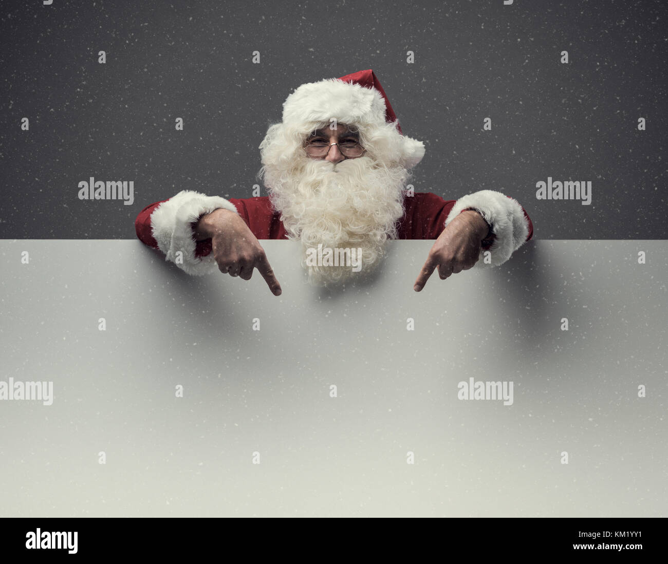 Cheerful Santa Claus pointing at a big blank sign, Christmas and ...