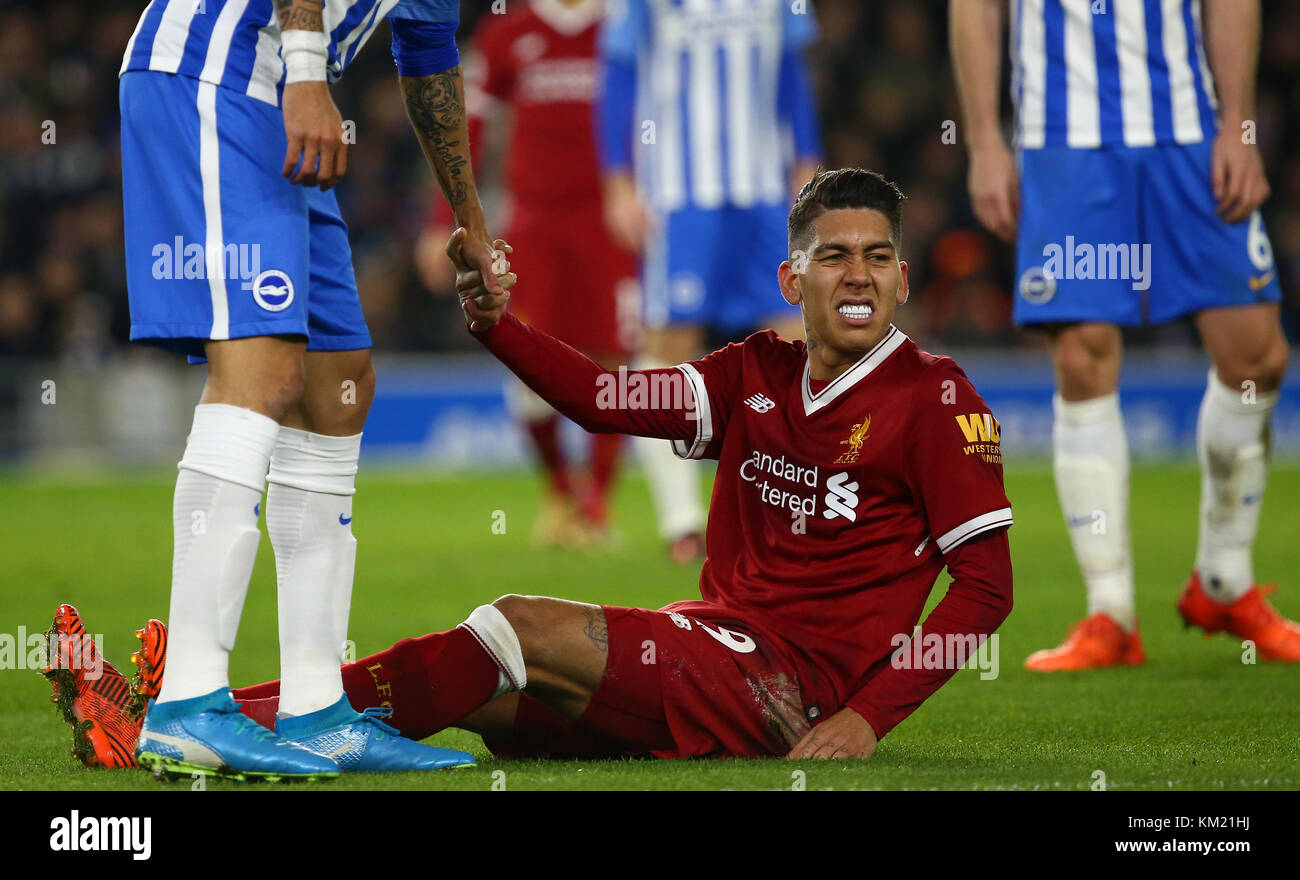 Roberto Firmino of Liverpool is helped to his feet after a heavy challenge during the Premier League match between Brighton and Hove Albion and Liverpool at the American Express Community Stadium in Brighton and Hove. 02 Dec 2017 *** EDITORIAL USE ONLY *** FA Premier League and Football League images are subject to DataCo Licence see www.football-dataco.com Stock Photo