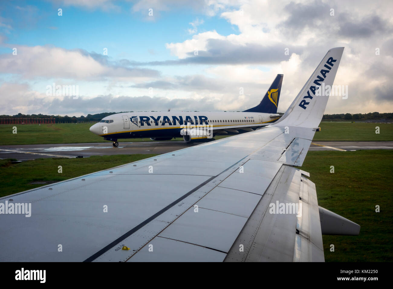 View of a Ryanair plane, aeroplane, airplane, waiting to enter the runway from inside another plane, Stansted Airport, UK Stock Photo