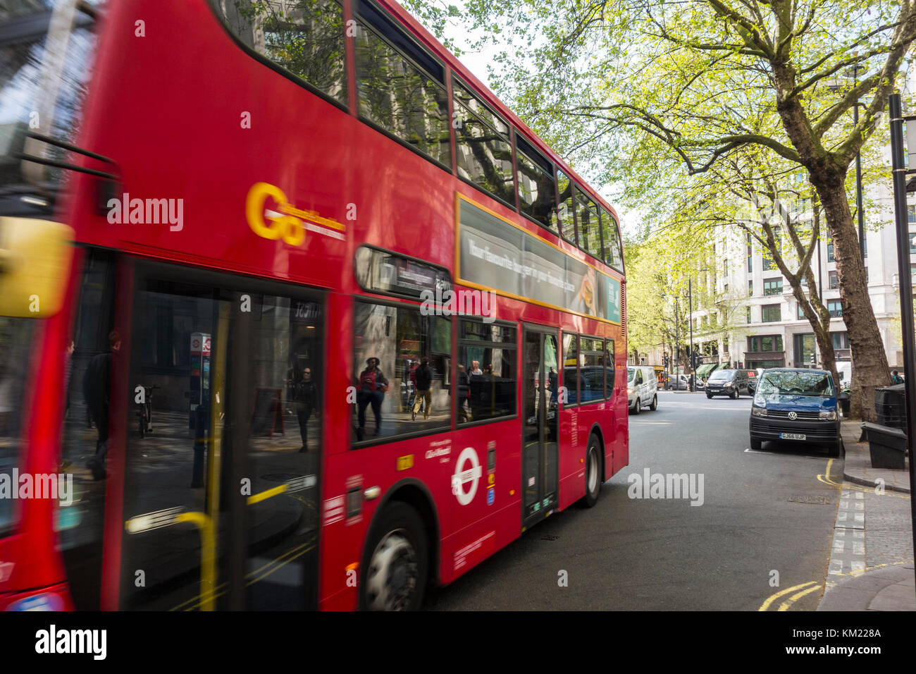 Reflections of people on the pavement in a red London bus, UK Stock Photo