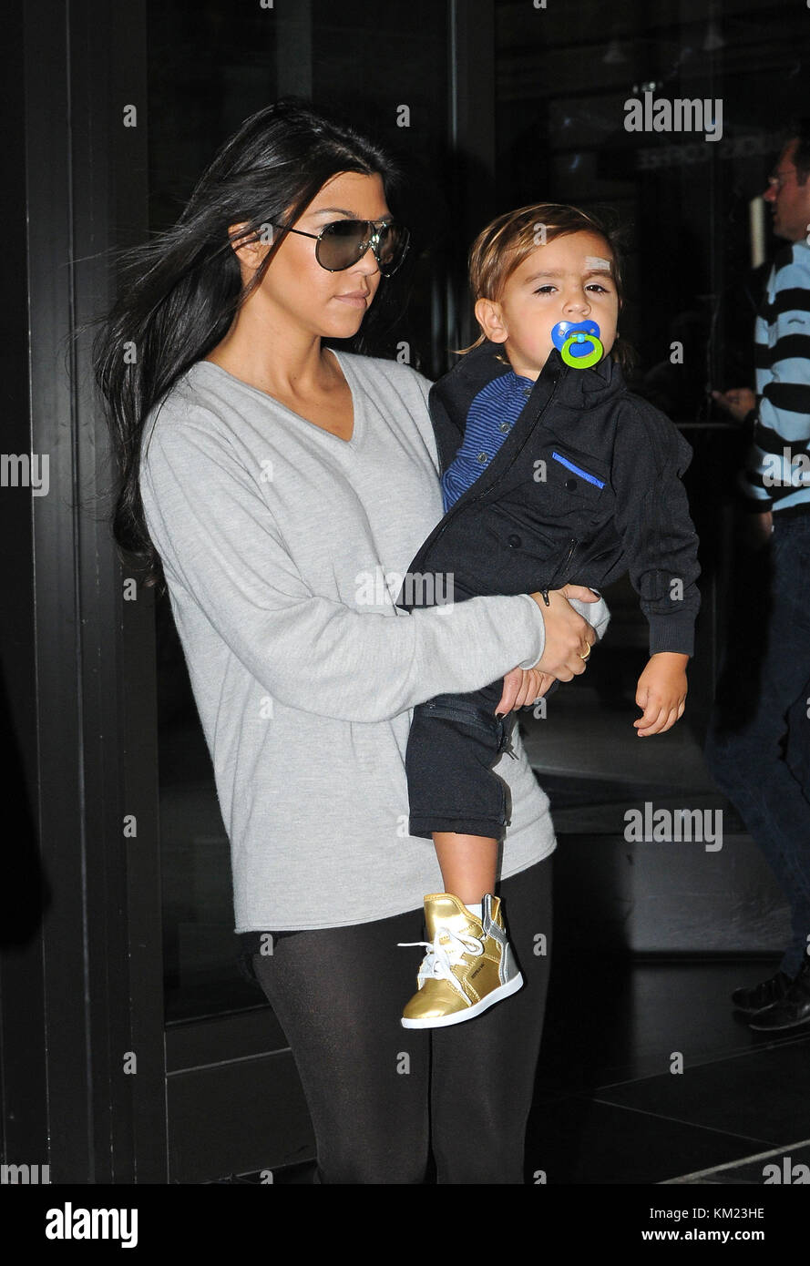 NEW YORK, NY SEPTEMBER 17 Kourtney Kardashian carries her son Mason