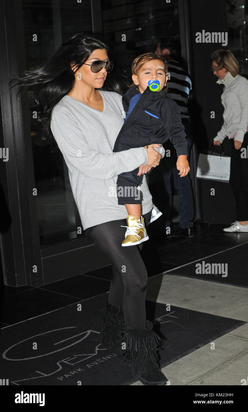 NEW YORK, NY SEPTEMBER 17 Kourtney Kardashian carries her son Mason