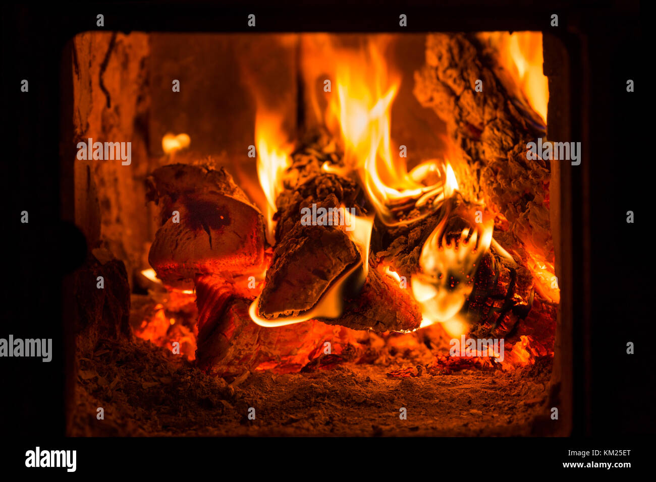 Fire and coals in brick fireplace furnace Stock Photo