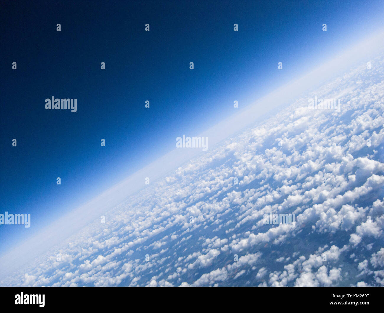 The horizon and clouds of planet Earth as seen from high above in this aerial image taken from a high altitude weather balloon Stock Photo