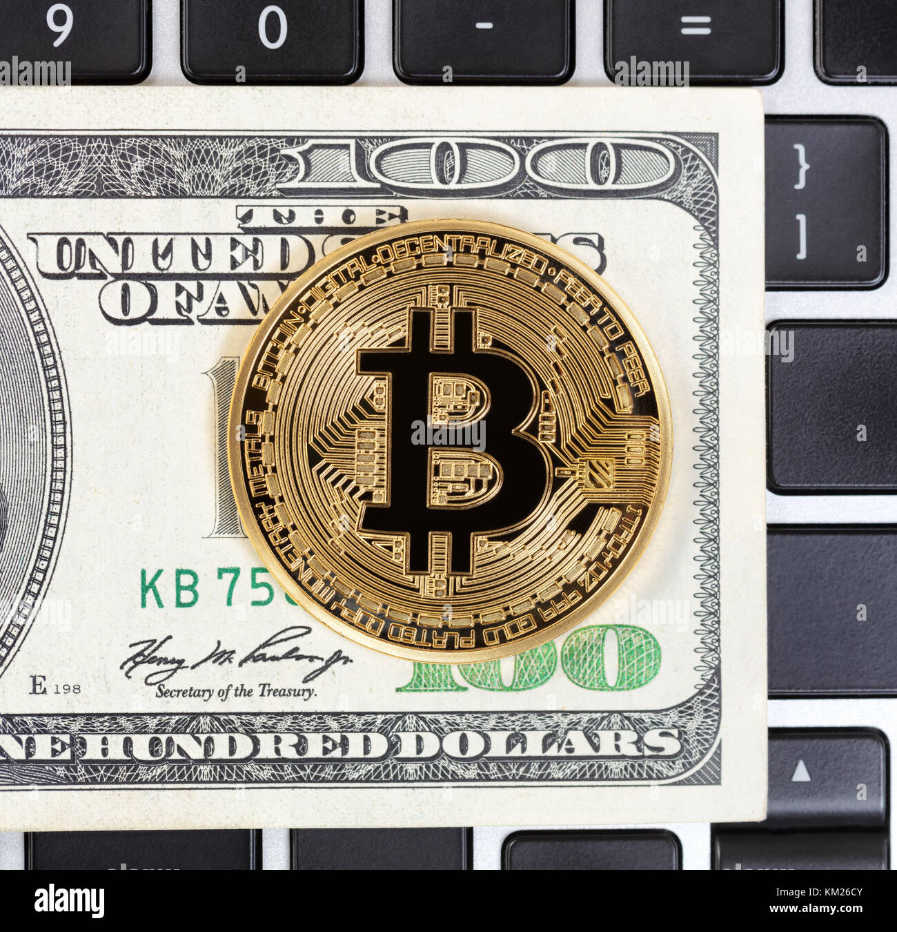 Bitcoin cyber single coin on keyboard with paper currency background Stock Photo
