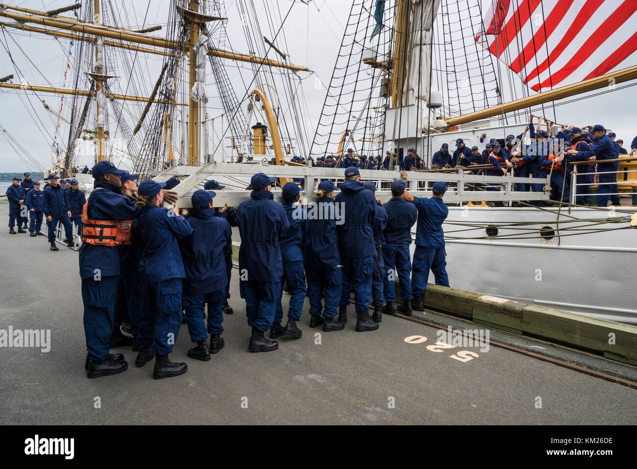 Crew of United States Coast Guard Barque 'Eagle' placing the ship's gangplank during arrival in Halifax, Nova Scotia, Canada for RDV 2017. Stock Photo