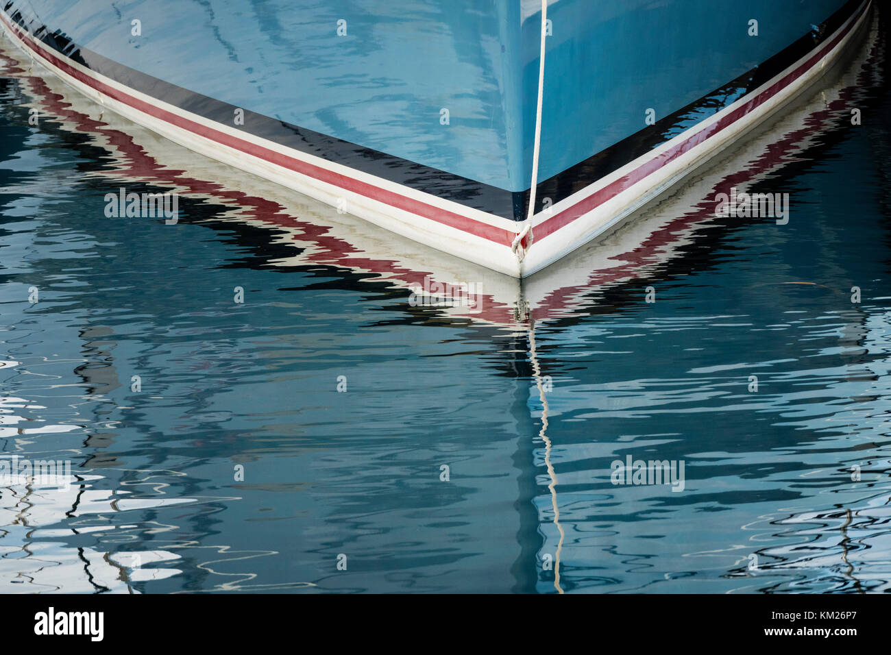 Waterline reflections of a fibreglass sailing yacht. Stock Photo