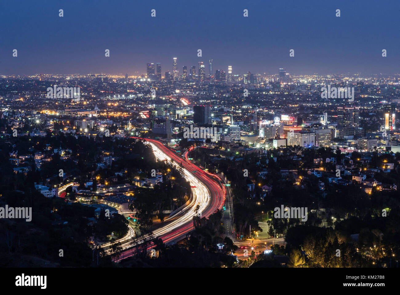 Los Angeles at night with cars streaking down the interstate, seen from