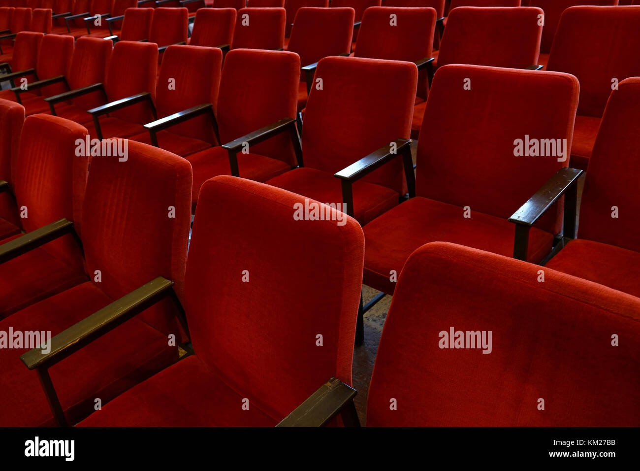 Close up red soft chair seats in a row, personal perspective, high angle view Stock Photo
