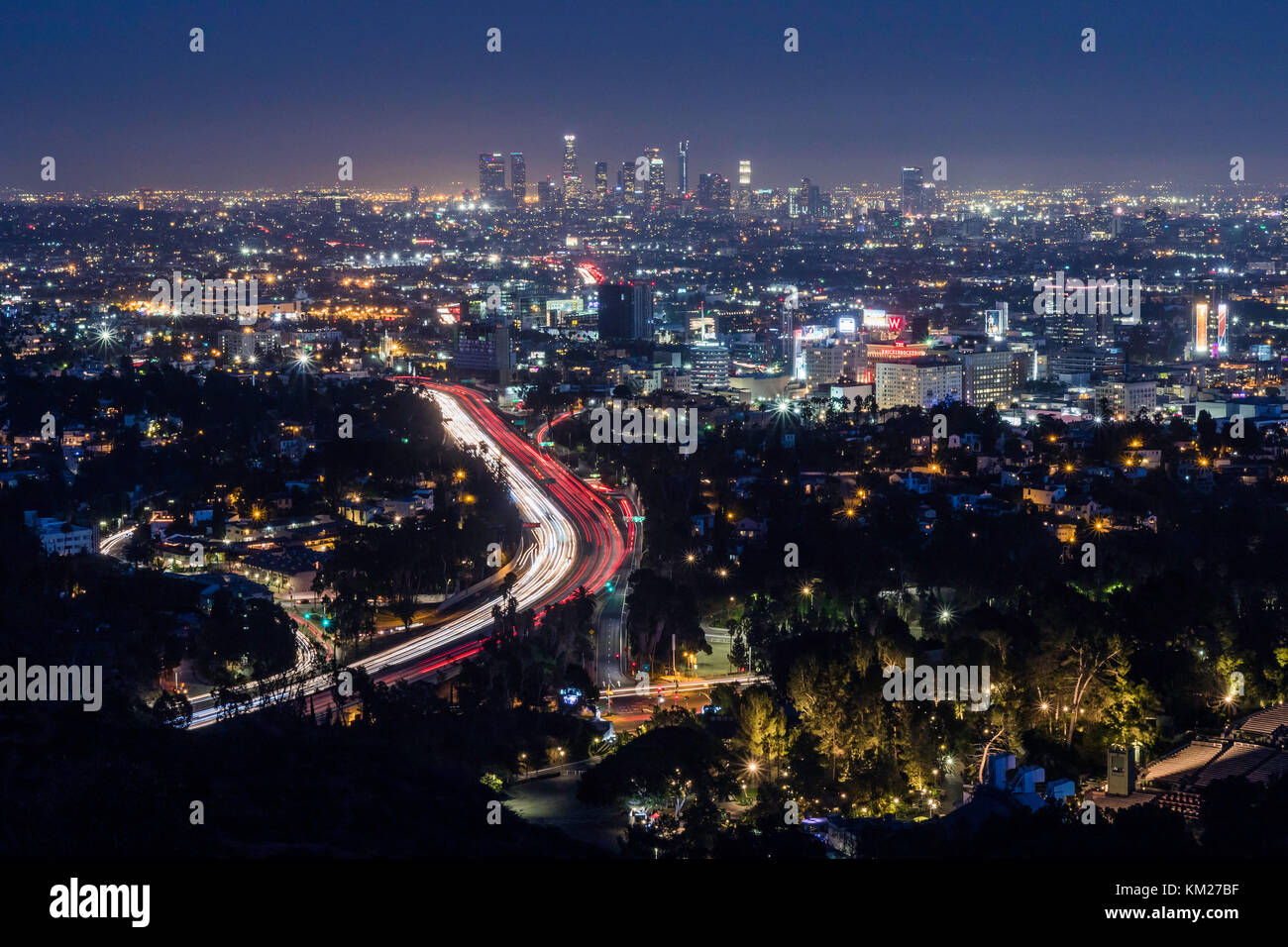 Los Angeles at night with cars streaking down the interstate, seen from