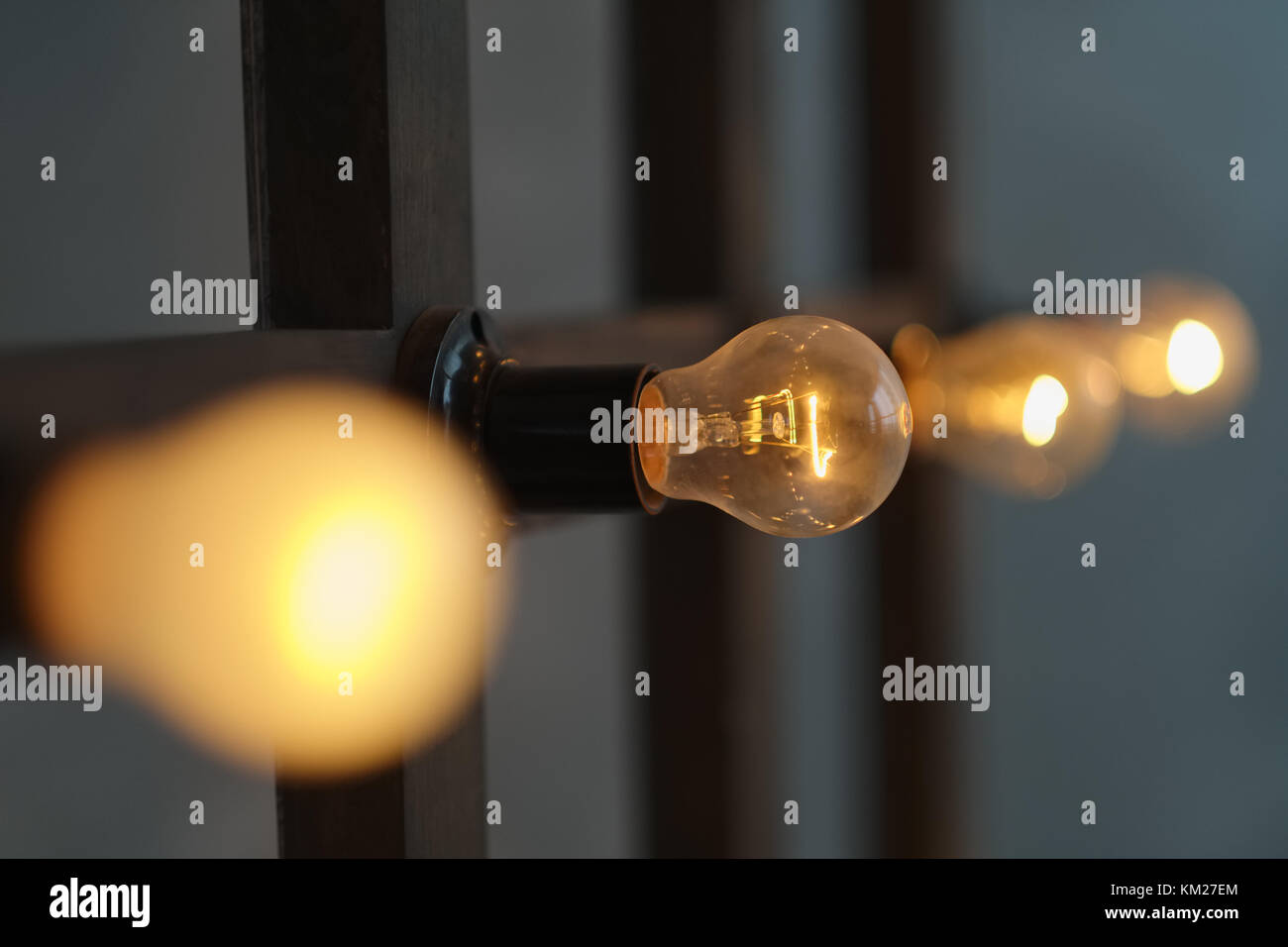 Old edison lamp mounted on wooden background Stock Photo - Alamy
