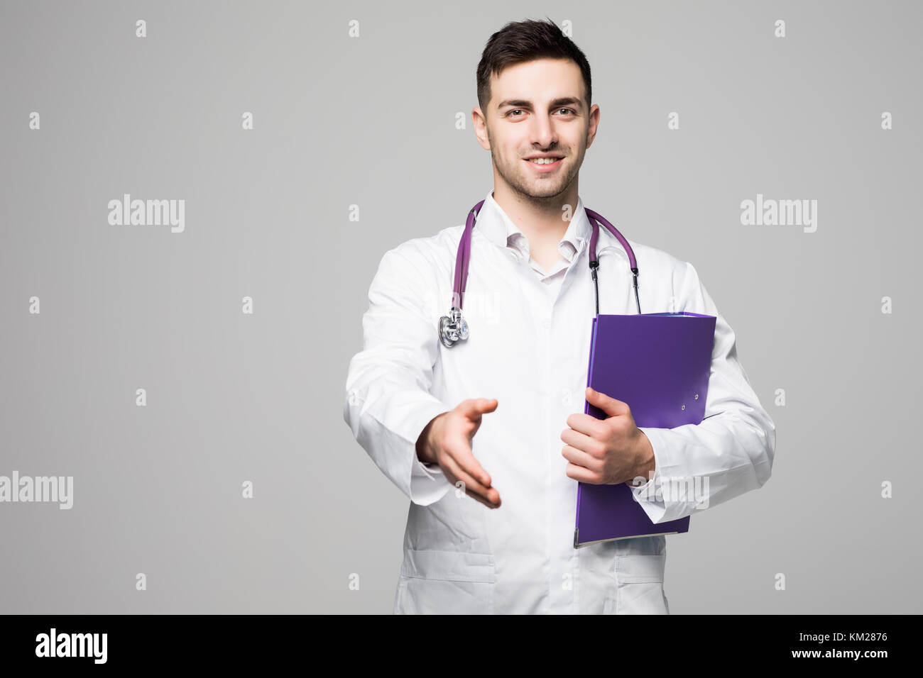 Handsome doctor holding folder hi-res stock photography and images - Alamy