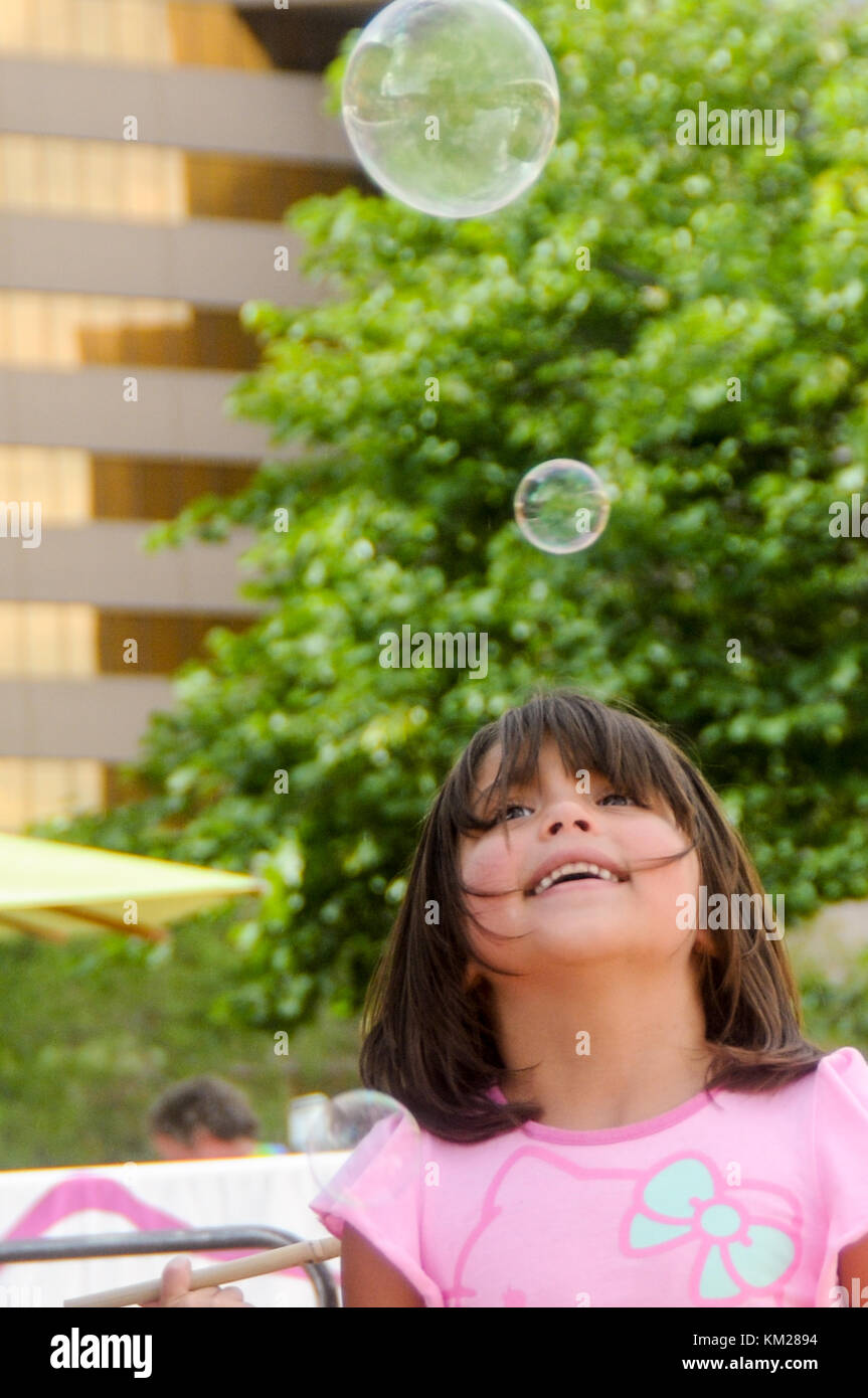 Kids playing with soap bubbles outside Stock Photo - Alamy