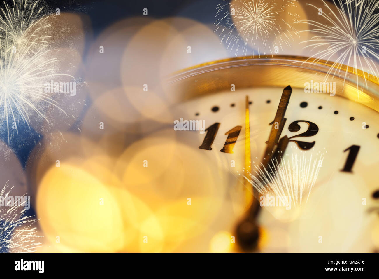 old clock at twelve o'cklock on holiday fireworks background - New Year's Stock Photo