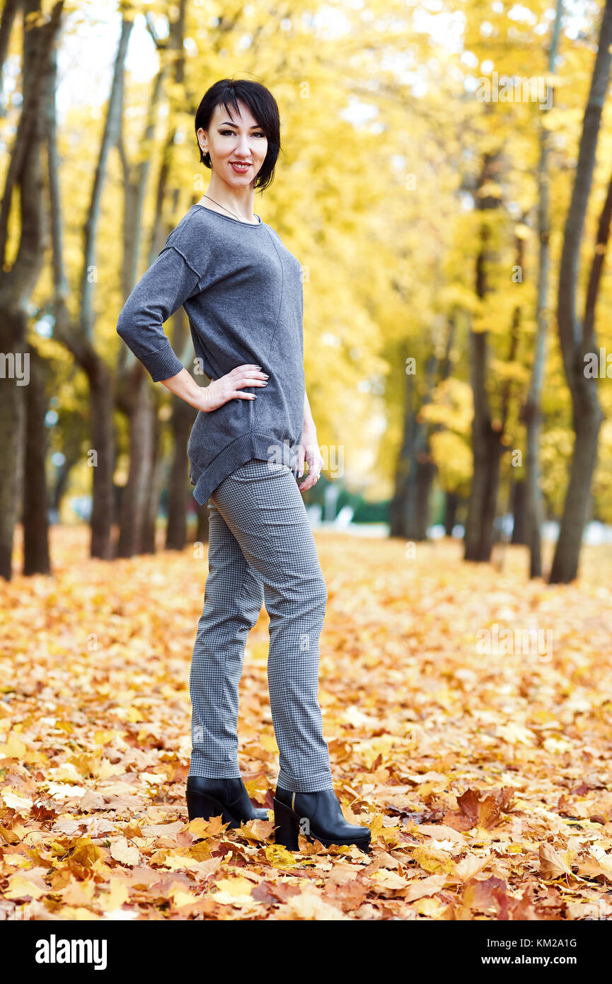young woman posing in autumn park with yellow trees, fall season Stock ...