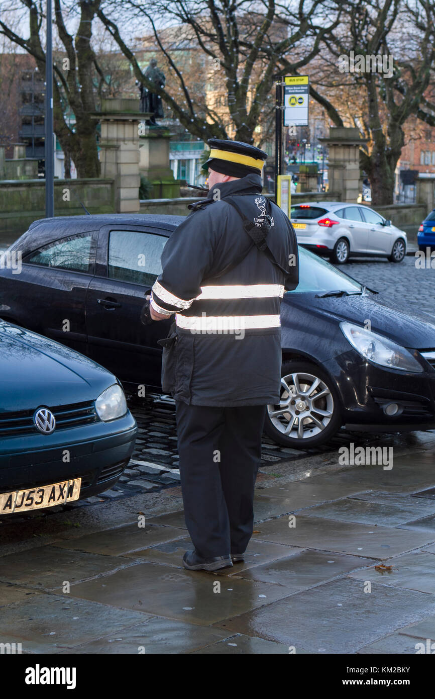 Traffic warden or civil enforcement officer issuing parking tickets in Liverpool city centre, merseyside, UK. Stock Photo