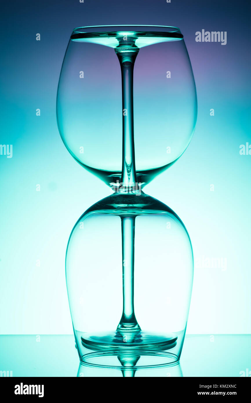 Two empty wineglass for red wine on diffusion lit background in abstract   composition with reflection, advertizing shot for restaurant, winemaking Stock Photo