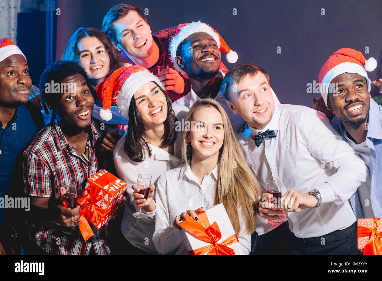 Group of beautiful young people in Santa hats looking a side Stock ...