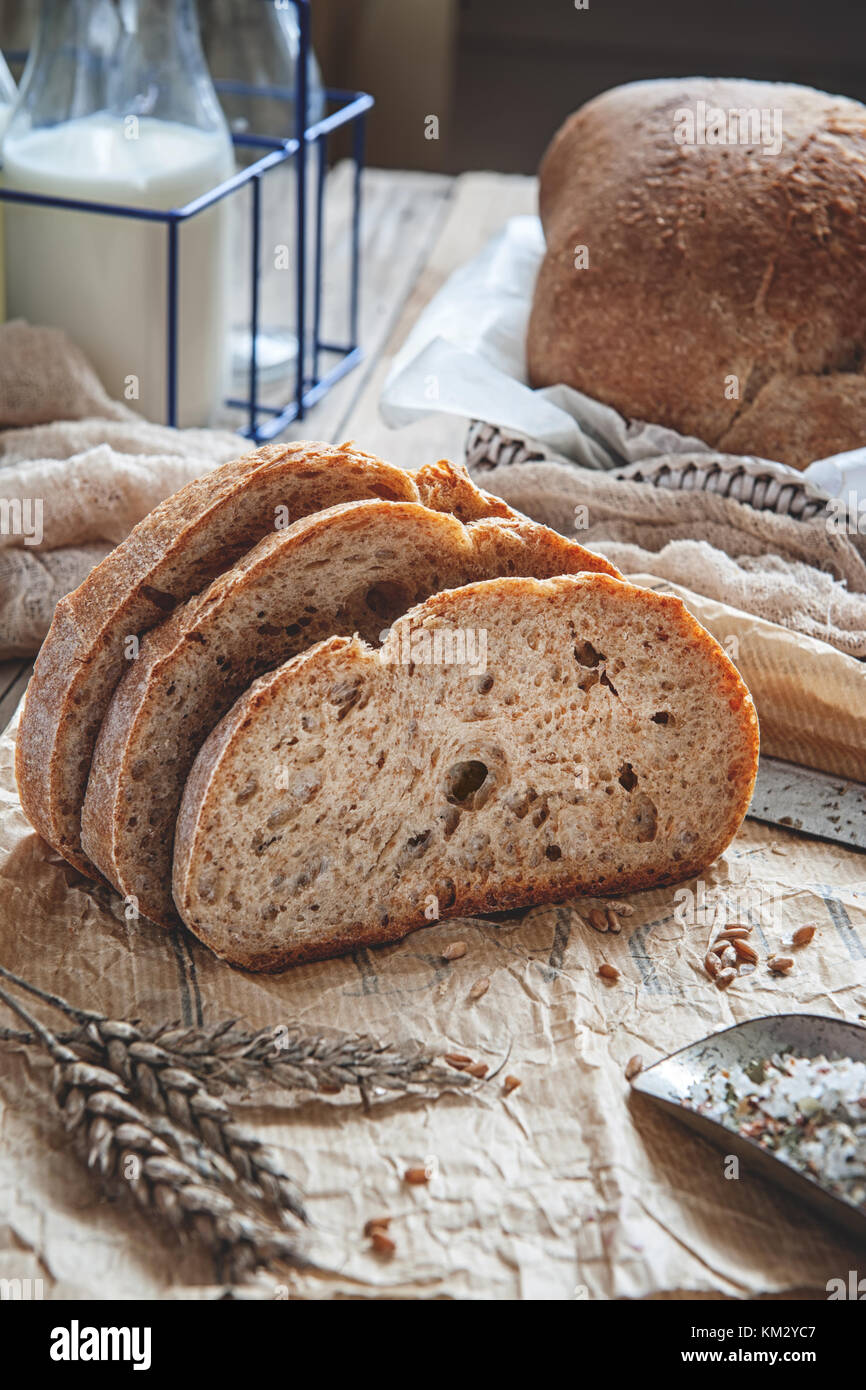 A beautiful loaf of sourdough bread from white wheat on a plate on a linen edge. Homemade