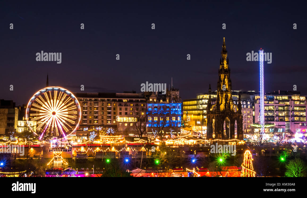 View across Princes Street Gardens to Forth 1 Big Wheel, Scott Monument and Star flyer fairground ride, celebrating Edinburgh Christmas, Scotland, UK Stock Photo