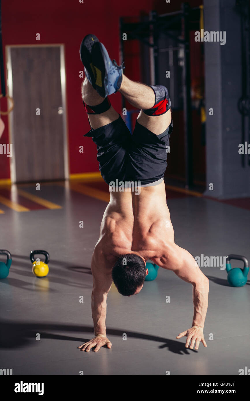 Handstand pushup man workout at gym Stock Photo Alamy