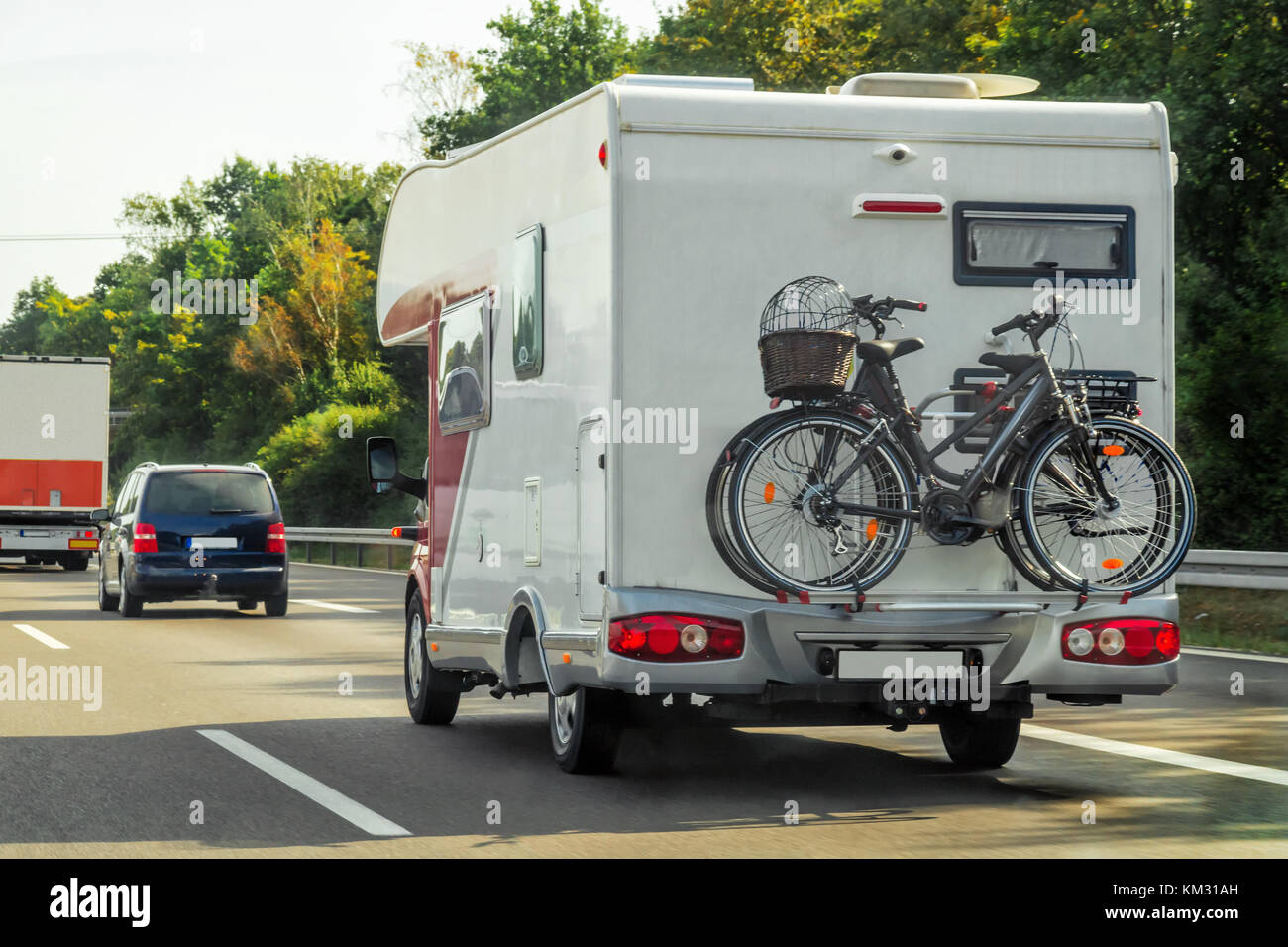 Caravan with bicycles and cars on the road of Switzerland Stock Photo -  Alamy