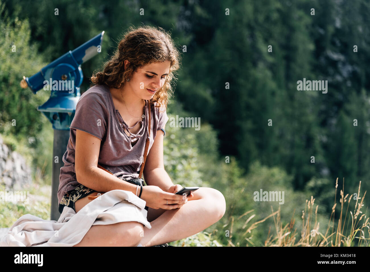 Portrait of young woman serious and sitting in viewpoint in the  Stock Photo