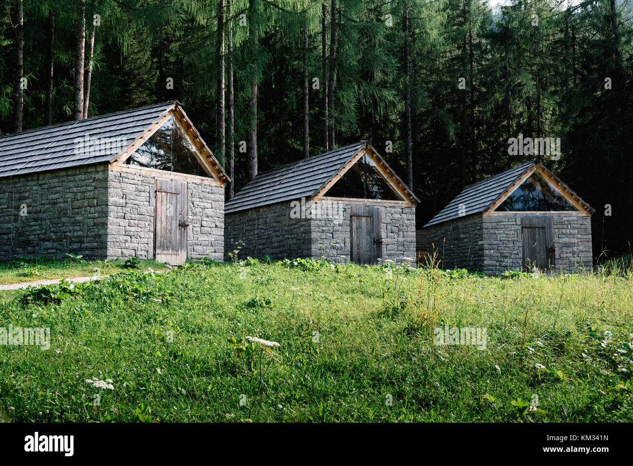 Three stone and wood cottages in the mountain Stock Photo