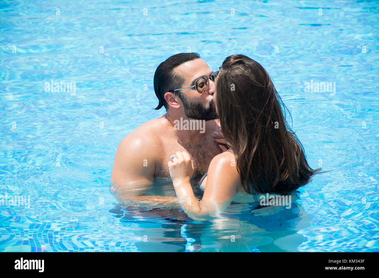Man and woman kissing in the swimming pool Stock Photo